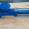 A small blue Fludyn BE4H progressing cavity pump, without motor, bolted crosswise on a wooden pallet